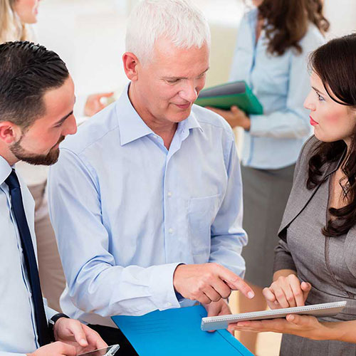 Professional outsourced company financial director talking to colleagues