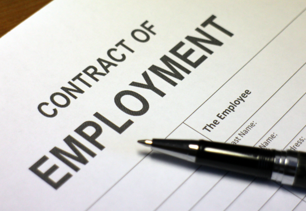 employment rights bill image shows white paper contract of employment with pen on desk